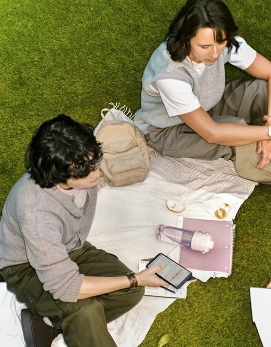 Two people having a picnic on the grass